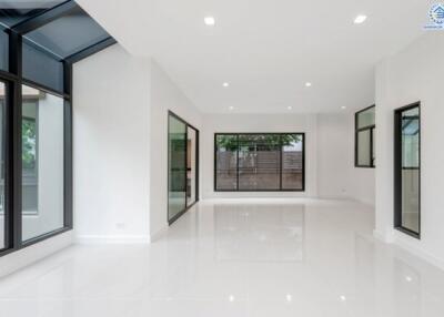 Spacious living room with large windows and natural light