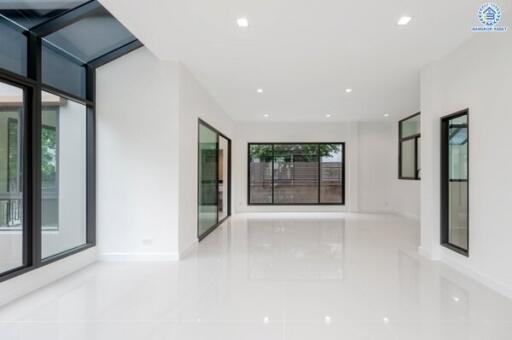 Spacious living room with large windows and natural light