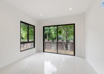 Bright and spacious main living area with large windows and sliding glass door