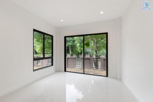 Bright and spacious main living area with large windows and sliding glass door