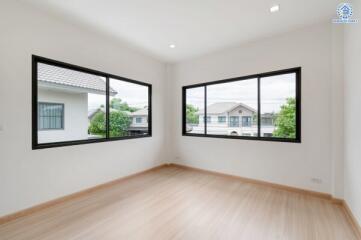 Empty bedroom with large windows