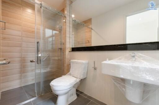 Modern bathroom with glass shower, toilet, and sink