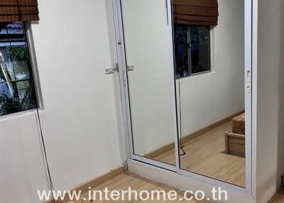 Bedroom with mirrored closet and window