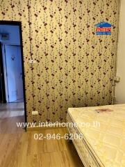 Bedroom with floral wallpaper and mattress