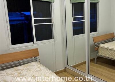 Bedroom with mirrored wardrobe and bed