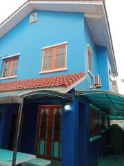 Exterior view of a blue two-story house