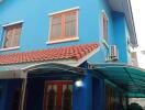 Exterior view of a blue two-story house