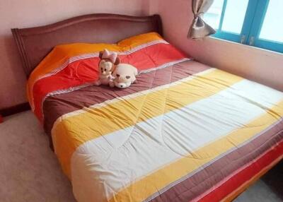 Cozy bedroom with colorful bedding and soft toys