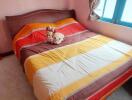 Cozy bedroom with colorful bedding and soft toys