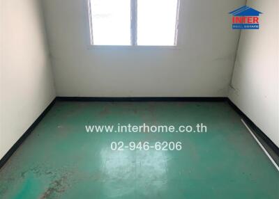 empty room with green floor and window