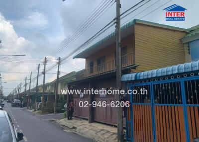 Street view of residential houses with a real estate sign