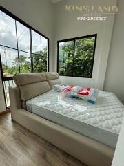 Modern bedroom with large windows and a new mattress