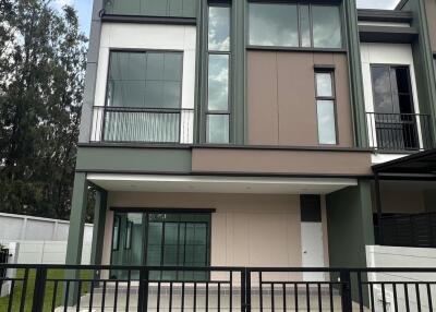 Modern two-story house with large windows and a driveway