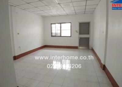 Spacious living room with tiled floor and ample natural lighting