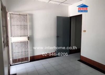 Empty room with tiled floor and window security grille