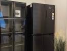 Black refrigerator and glass pantry cabinet