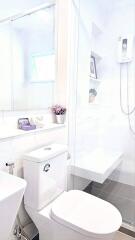 A modern bathroom with white fixtures and decor