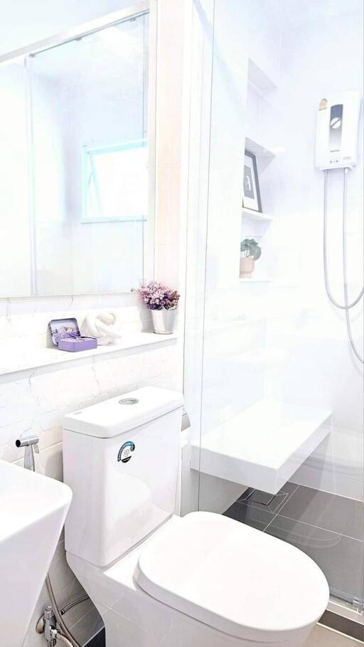 A modern bathroom with white fixtures and decor