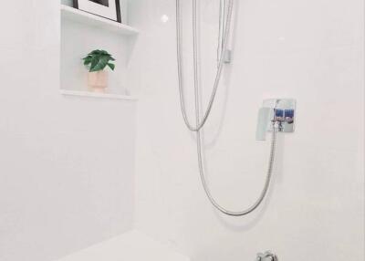 Modern bathroom with shower and wall-mounted water heater