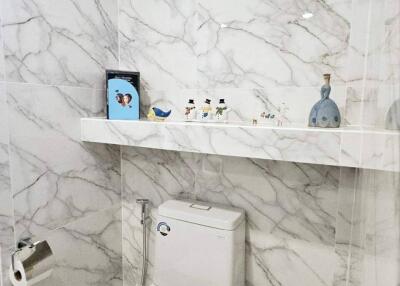 Modern bathroom with marble tile and toilet