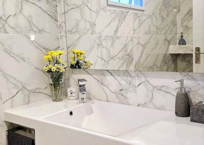 Modern bathroom with marble tiles and sink