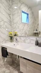 Modern bathroom with marble tiles and sink