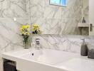 Modern bathroom with marble tiles and sink