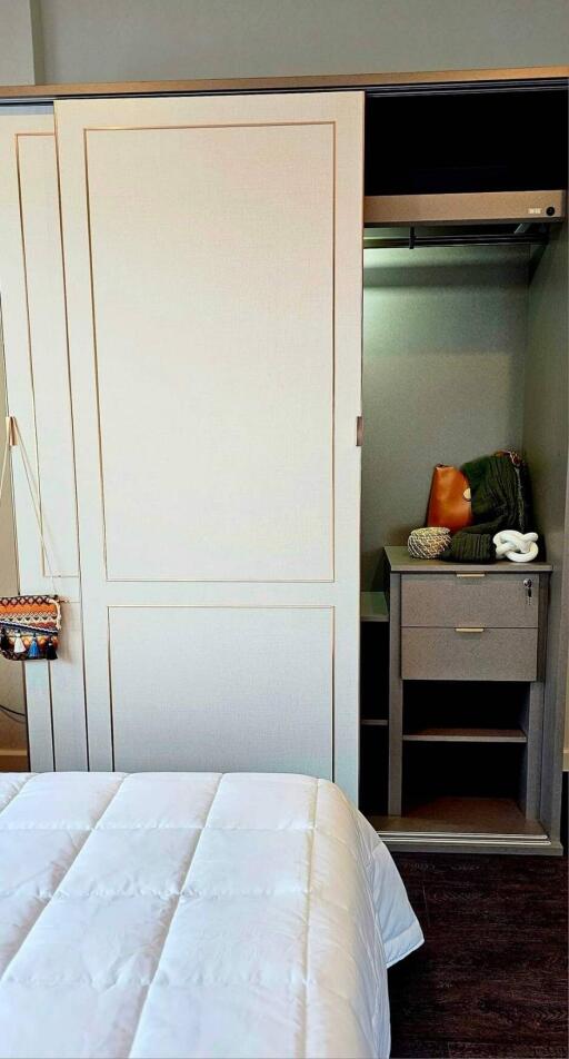 Bedroom wardrobe with open sliding door revealing shelves and storage space