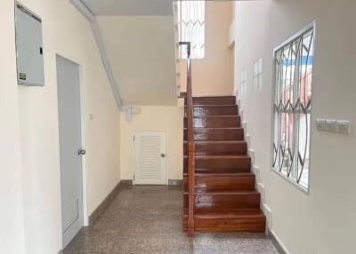 Interior view of a staircase with wooden steps in a well-lit area