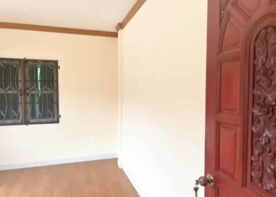 Spacious empty room with wooden door and window