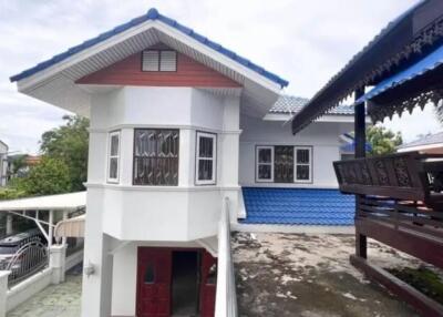 Exterior view of a two-story house with a unique design