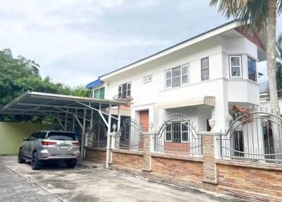 Exterior view of a house with a carport and driveway