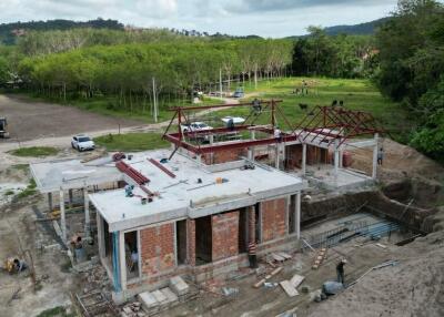 Construction site of a new property with visible framework and brick structure