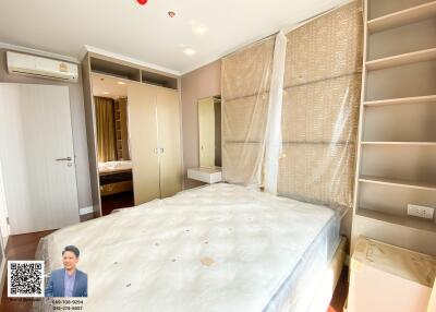 Spacious bedroom with ample natural lighting, fitted wardrobes, and modern furnishings