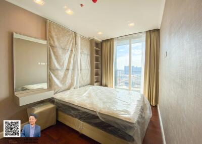 Modern bedroom with floor-to-ceiling windows and city view