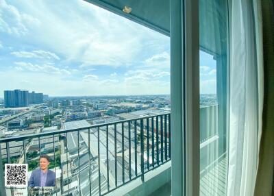 View of the city from a balcony with glass doors