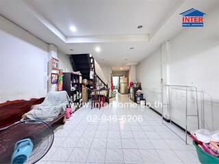 Open living area with staircase and tiled floor