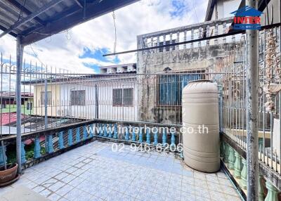 Outdoor area with tiled flooring and water tank