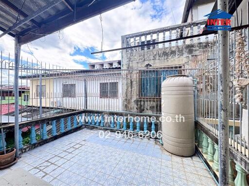 Outdoor area with tiled flooring and water tank