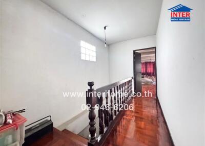 Stairway and hallway with a view into an adjacent room