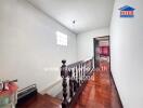 Stairway and hallway with a view into an adjacent room