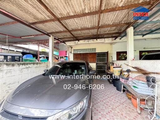 Covered garage with a car