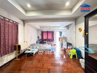 Main living area with wooden flooring and various furnishings