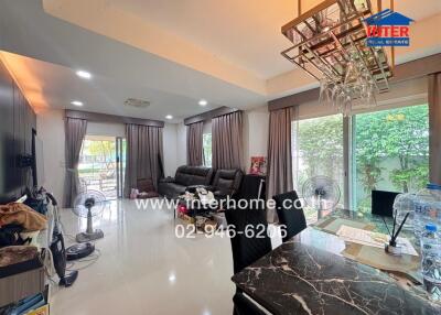 Spacious and modern living room with large windows, stylish decor, and ample natural light