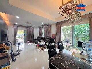 Spacious and modern living room with large windows, stylish decor, and ample natural light