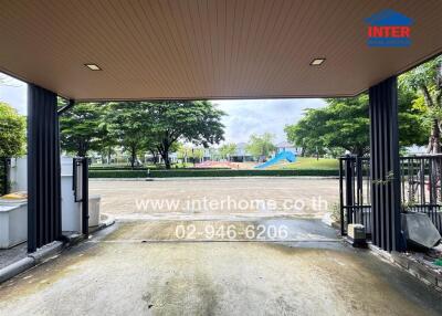 View from a garage towards a street with greenery