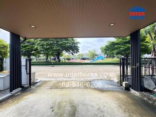 View from a garage towards a street with greenery