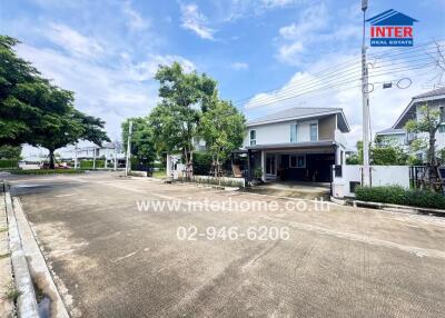 Residential street with white houses and greenery