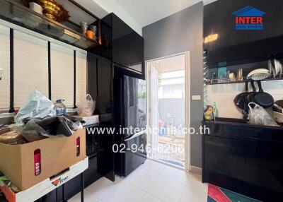 Modern kitchen with black cabinets and a small outdoor area