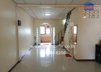 Spacious living room with staircase and archway